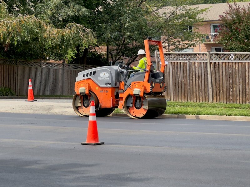 Worker preparing a road base for full-depth asphalt replacement